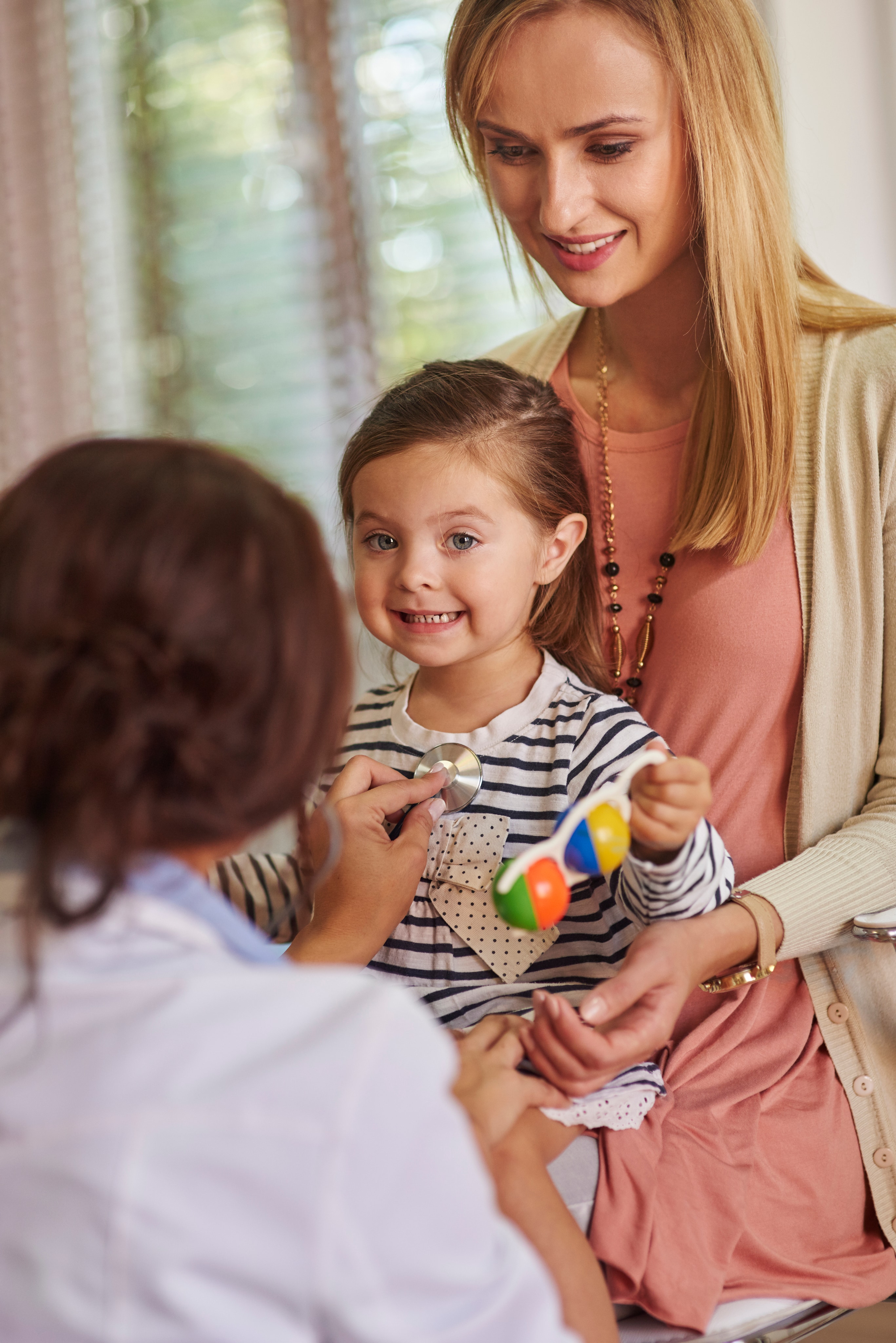 Care professional with a child during an exam